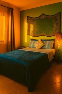 a bedroom with a large bed with a blue blanket at Ocean Hideaway - Sea View in Essaouira