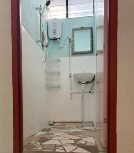 a bathroom with a sink and a mirror at Anchor Point Hostel and Cafe in Pulau Langkawi