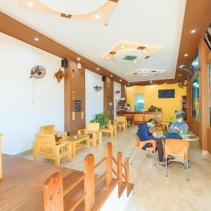 two men sitting in chairs in a waiting room at Phú Vang Hotel Pleiku in Pleiku