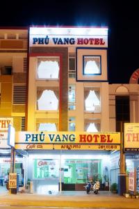 a building with ajit wing hotel in front of it at Phú Vang Hotel Pleiku in Pleiku