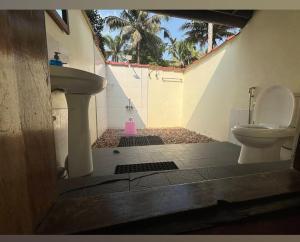 a bathroom with a toilet and a sink at Rice Village Home Stay in Alleppey