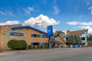 Un edificio con un cartel azul frente a una calle. en Rodeway Inn Lyons - La Grange, en Lyons