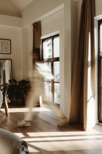 a person running through a living room with a window at Studio & Stay Loft in Ghent