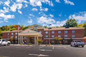 a large red brick building with a parking lot at Comfort Inn Dayton South in Dayton