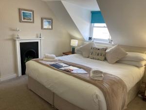 a bedroom with a large bed with a fireplace at The Mayfair in Weymouth +33 photos