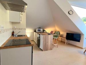 an attic kitchen with a sink and a counter top at Vila, 132 - II in San Cosme de Barreiros
