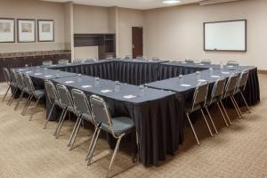 a conference room with a long table and chairs at Ramada by Wyndham Brooks in Brooks +49 photos