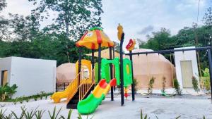 a playground with a slide and a play structure at TheNyaman Place in Hulu Langat