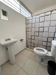 a bathroom with a toilet and a sink at Beach Apartment in Ciudad Madero