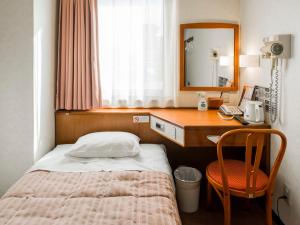 Postel nebo postele na pokoji v ubytování 南部ホテル