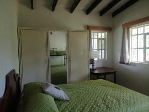 Ένα ή περισσότερα κρεβάτια σε δωμάτιο στο The House of the Hummingbird in Siguatepeque