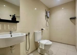 a bathroom with a sink and a toilet and a phone at Swing & Pillows - Chow Kit Road, Kuala Lumpur in Kuala Lumpur +31 photos