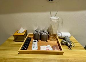 a wooden table with a remote control and a blender at Swing & Pillows - Chow Kit Road, Kuala Lumpur in Kuala Lumpur