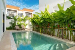 a swimming pool in front of a house at Goldena Residence Private Pool Villas in Kamala Beach