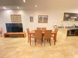 a kitchen and dining room with a table and chairs at Grand Bay 4Bed Triplex Villa with Community Pool in Grand Baie
