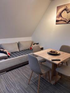 a living room with a couch and a table at Tri-M Konaci in Kopaonik