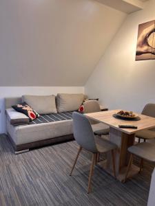 a living room with a couch and a table at Tri-M Konaci in Kopaonik