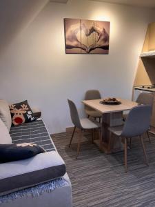 a living room with a table and a table and chairs at Tri-M Konaci in Kopaonik