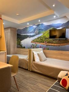 a hotel room with a river mural on the wall at Tri-M Konaci in Kopaonik