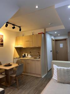 a kitchen and a living room with a table at Tri-M Konaci in Kopaonik +71 photos