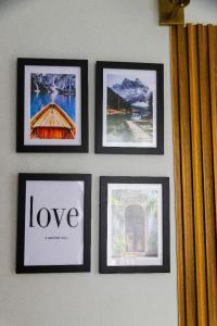 a group of four framed pictures on a wall at Sunset Lodge Salasala in Dar es Salaam