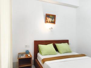 Ένα ή περισσότερα κρεβάτια σε δωμάτιο στο BC Inn Senggigi RedPartner