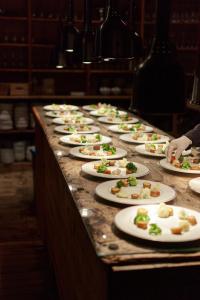 a row of plates of food on a table at STØTT top of Helgeland in Støtt +21 photos