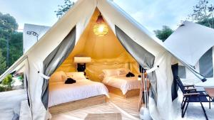 two beds in a tent with two cats on them at TheNyaman Place in Hulu Langat +56 photos