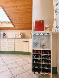 a kitchen with a shelf full of wine bottles at FeWo Honstein in Pfronten