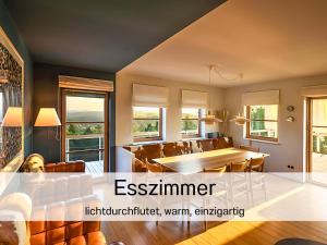 a dining room and living room with a table and chairs at Valentyns Farmhaus in Bad Münstereifel +24 photos