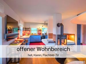 an open kitchen and living room with a stove at Valentyns Farmhaus in Bad Münstereifel