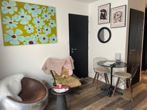 a living room with a chair and a table at cocoon romantique avec jacuzzi proche plage in Saint-Gildas-de-Rhuys