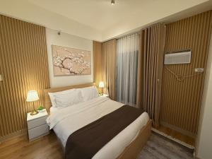 a hotel room with a large bed and a window at The Banyan Rest in Balibaguhan