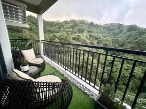 a balcony with chairs and a view of a mountain at The Banyan Rest in Balibaguhan