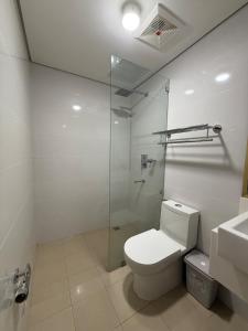 a bathroom with a toilet and a glass shower at The Banyan Rest in Balibaguhan +26 photos