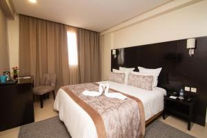 Postel nebo postele na pokoji v ubytování Hôtel du Golf Mohammedia