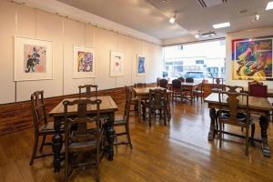 a dining room with wooden tables and chairs at Fukuyama Terminal Hotel in Fukuyama