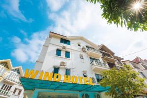 a white building with a wind hotel sign on it at Wind Hotel in Hanoi