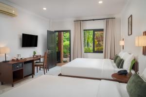 Ένα ή περισσότερα κρεβάτια σε δωμάτιο στο Green Morodoc Garden Hotel +22 φωτογραφίες