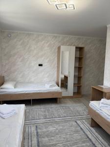 Postel nebo postele na pokoji v ubytování BUGU Guest House