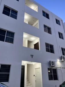 a white building with a white door in front at Noir Beach Suite in Ciudad Madero