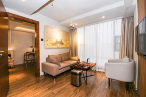 a living room with a couch and a table at Chenlong Cafe Hotel in Guangzhou +25 photos