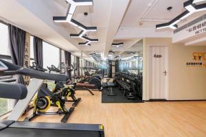 a gym with cardio equipment and treadmills at Chenlong Cafe Hotel in Guangzhou