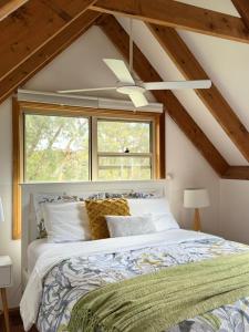 a bedroom with a large bed with a window at Lower Mountains Retreat in Warrimoo