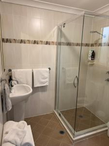 a bathroom with a shower and a sink at Lower Mountains Retreat in Warrimoo
