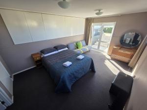 a bedroom with a bed and a television in it at The Retreat Taupo in Taupo