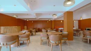 a dining room with wooden tables and chairs at Zhangjiajie Valley Secret Resort in Zhangjiajie