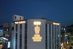 a building with a sign on the top of it at Hotel MarieStay Taean in Taean