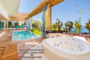 a bath tub in a house with a swimming pool at Seaview Faralya in Faralya