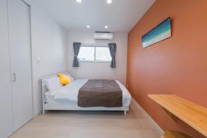 En eller flere senge i et værelse på ガーデンヴィラミヤコアネックスエー